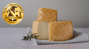 Cabra al Gofio cheese with World Championship Cheese logo