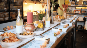 Fancy table with samples of kimchi and cheese on it