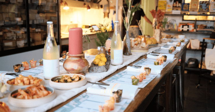 Fancy table with samples of kimchi and cheese on it