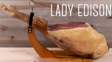 Leg of country ham on a stand with Lady Edison logo
