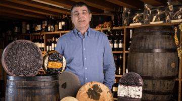 Affineur Sergio Moro behind an array of his cheeses