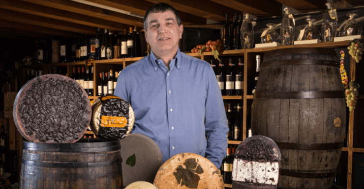 Affineur Sergio Moro behind an array of his cheeses